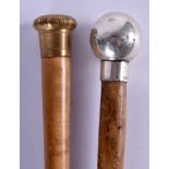 AN ANTIQUE SILVER MOUNTED MALACCA WALKING CANE and another. 90 cm long. (2)