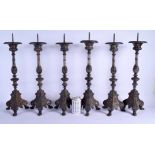 A RARE SET OF SIX EARLY 19TH CENTURY CONTINENTAL SILVER PLATED PRICKET CANDLESTICKS upon acanthus ca