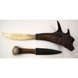 A CONTINENTAL CARVED ANTLER HORN PAPER KNIFE and another. (2)