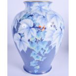 A 19TH CENTURY JAPANESE MEIJI PERIOD PORCELAIN FLOWER VASE painted upon a seaweed blue ground. 26 cm