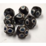 EIGHT ISLAMIC BEADS. (8)