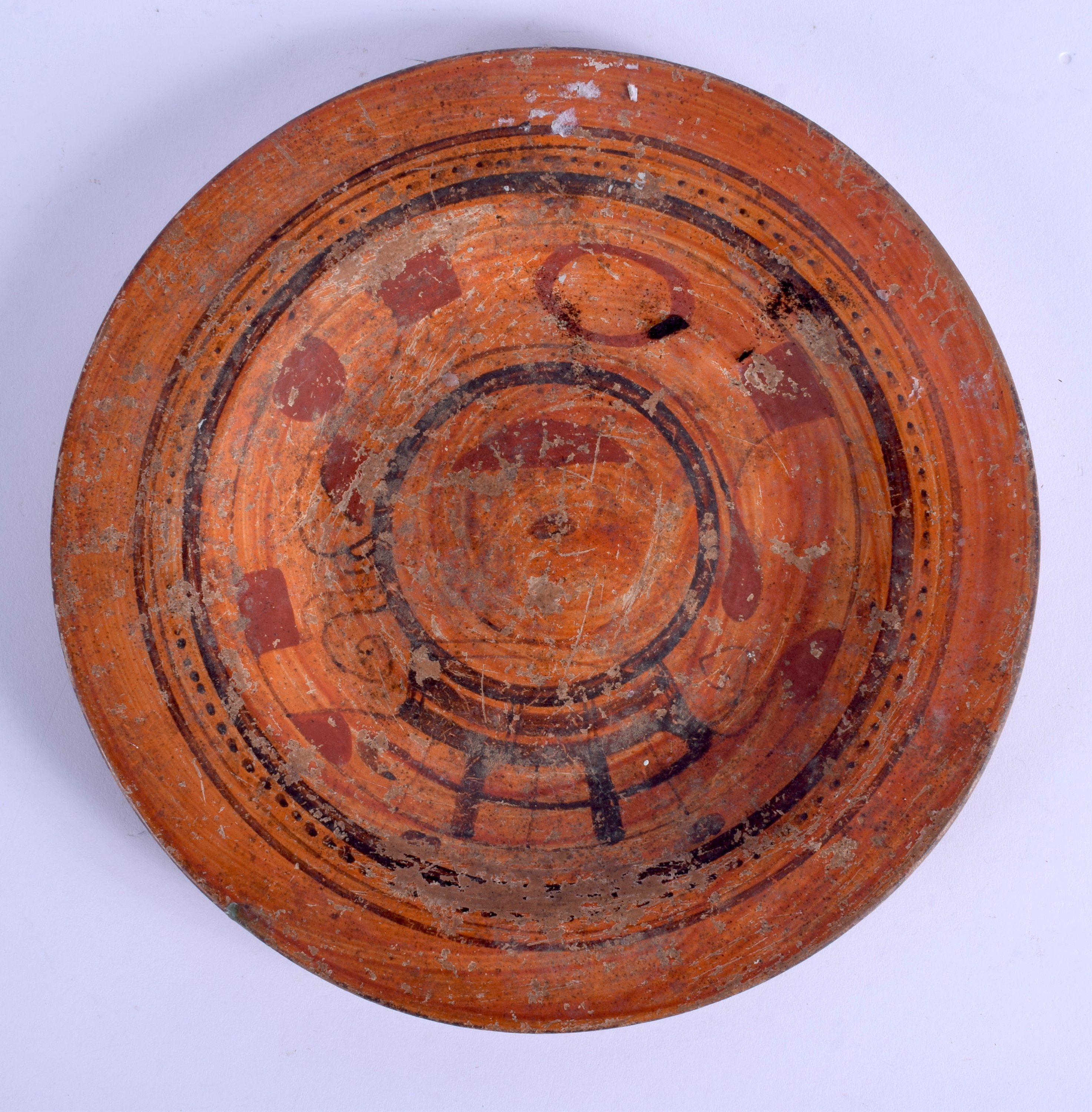 AN EARLY CONTINENTAL SOUTH EUROPEAN TERRACOTTA DISH After the Antiquity, painted with iron red motif