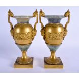 A FINE PAIR OF MID 19TH CENTURY FRENCH ORMOLU AND FELDSPAR VASES decorated with mask heads and weapo