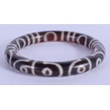 A CHINESE TIBETAN CARVED AGATE BANGLE 20th Century. 7.5 cm wide.