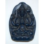 A CHINESE CARVED LAPIS LAZULI TYPE CARVED PENDANT, depicting a seated buddha. 6.5 cm x 4.5 cm.