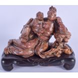 AN EARLY 20TH CENTURY CHINESE CARVED SOAPSTONE FIGURE OF TWO FIGURES Qing, modelled reclining. 16 cm