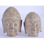 TWO 1930S CHINESE CARVED STONE BUDDHA HEADS Yuan/Ming style. 11 cm & 9 cm high. (2)