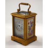 A MINIATURE CARRIAGE CLOCK. 7 cm high inc handle.