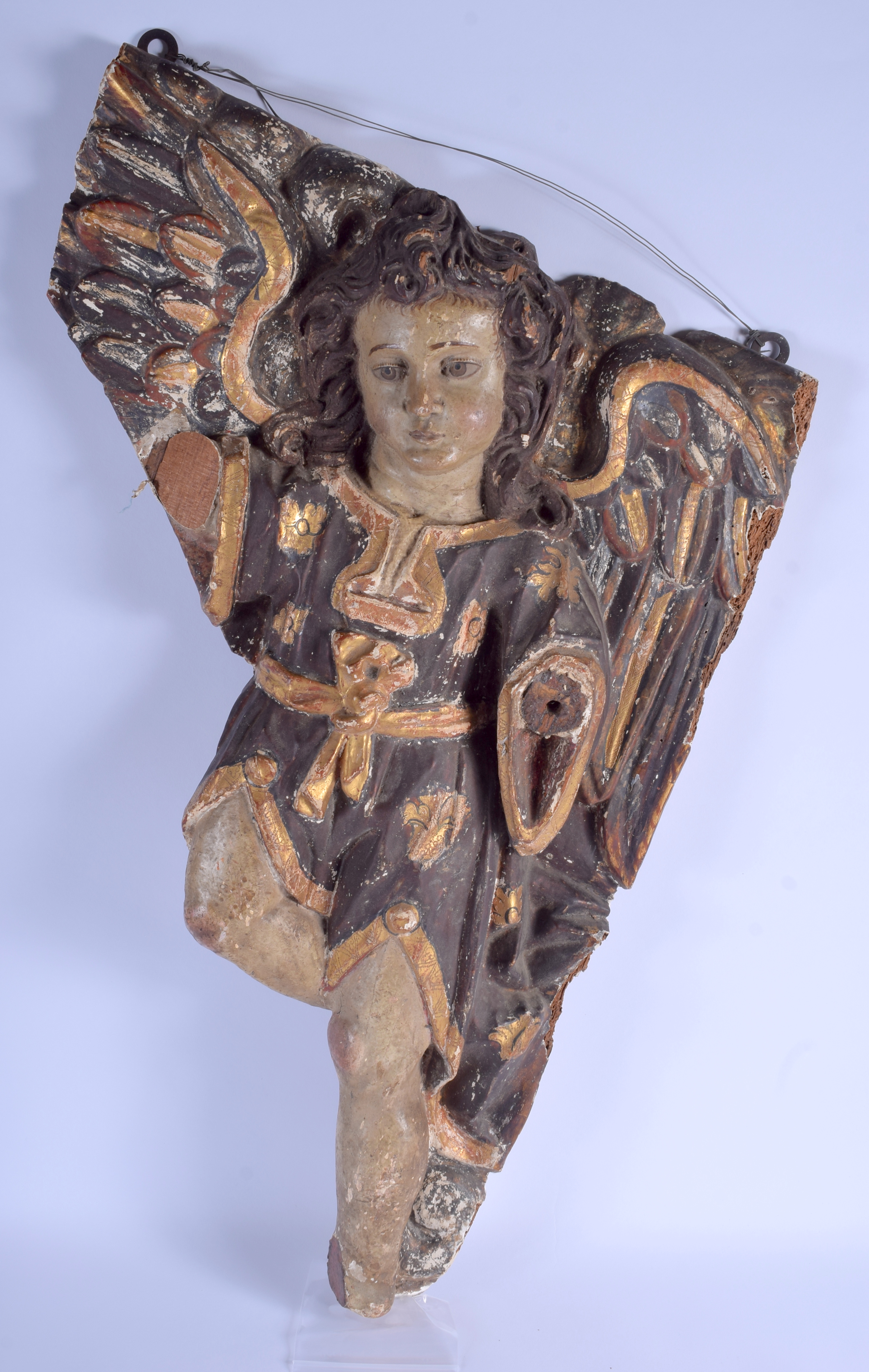 A 17TH/18TH CENTURY NORTH EUROPEAN CARVED AND POLYCHROMED WOOD HANGING ANGEL decorated with motifs.