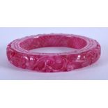 A CHINESE CARVED PURPLE JADE BANGLE. 7.5 cm wide.