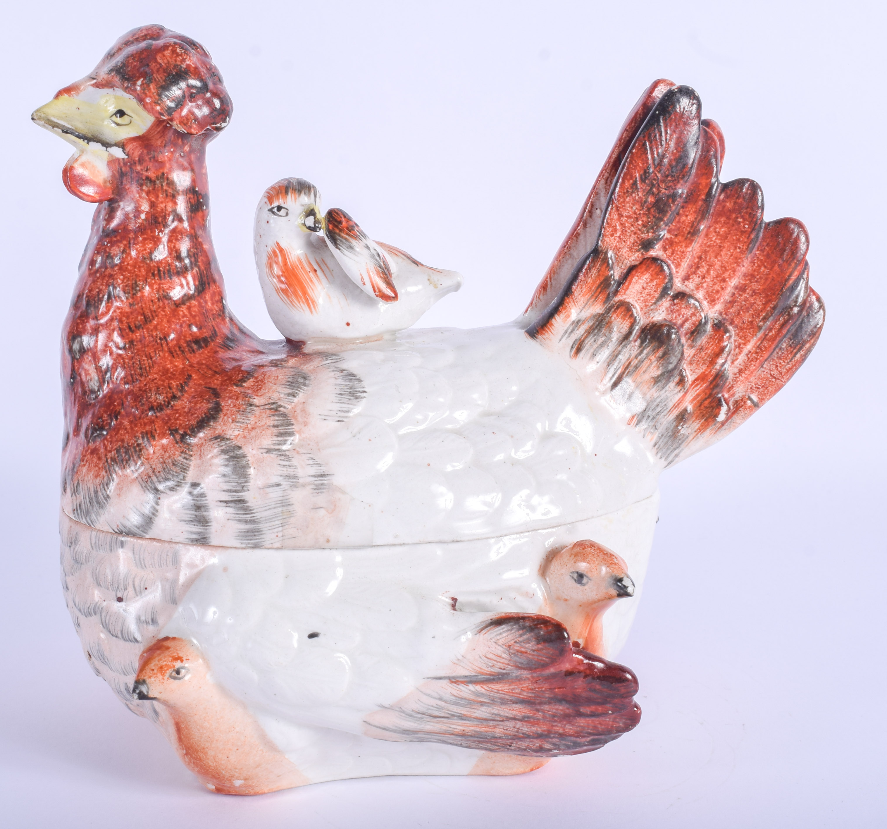 AN EARLY 19TH CENTURY YORKSHIRE POTTERY HEN TUREEN AND COVER modelled with chicks. 18 cm x 18 cm.