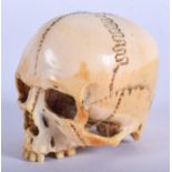A RARE 18TH CENTURY SOUTH GERMAN CARVED IVORY SKULL of naturalistic form. 5.5 cm x 4.5 cm. Note: For