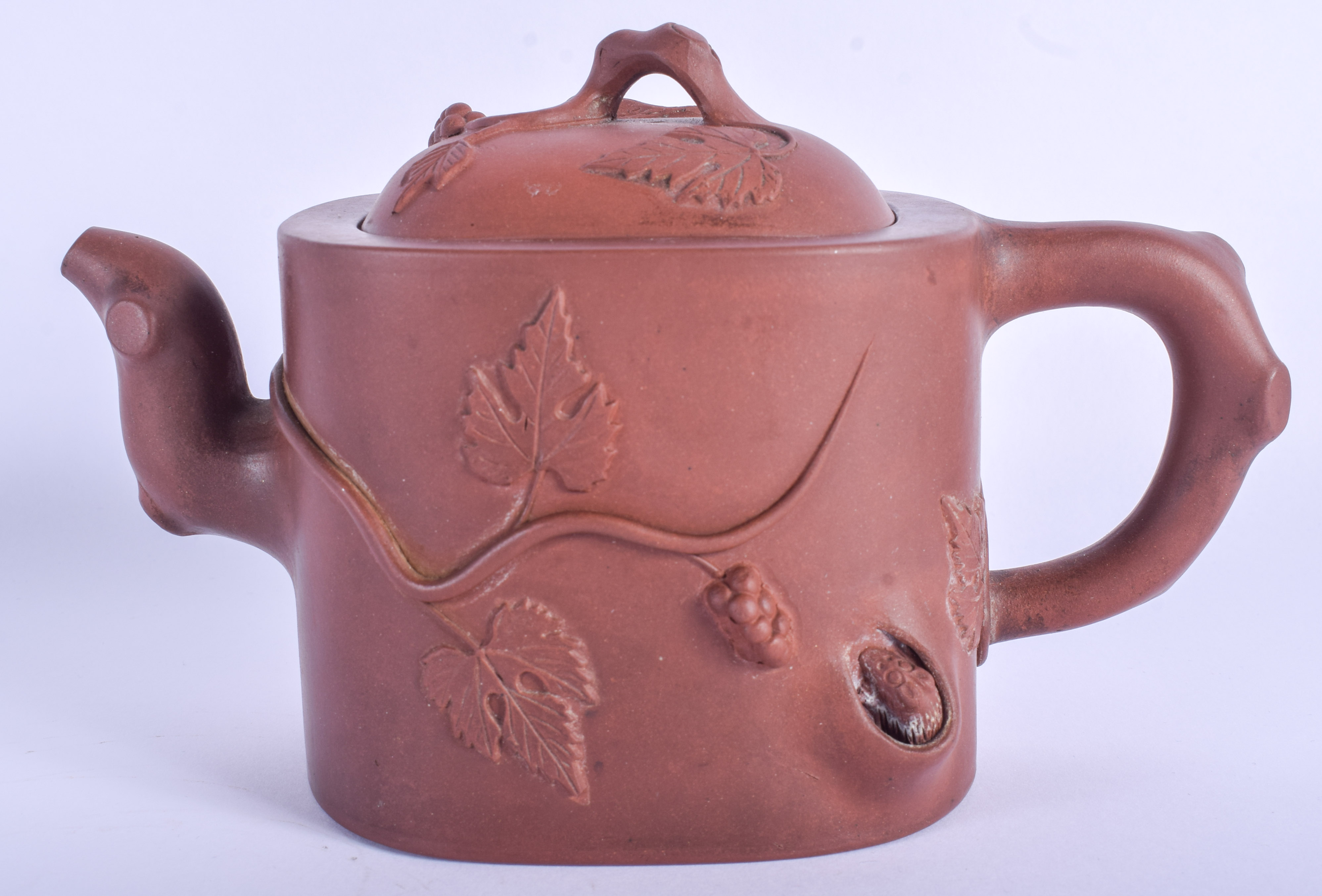 AN EARLY 20TH CENTURY CHINESE YIXING POTTERY TEAPOT AND COVER decorated with foliage. 18 cm wide.