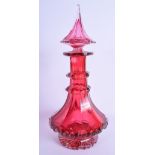 A LARGE ANTIQUE CRANBERRY GLASS LIQUOR DECANTER AND STOPPER modelled in the Middle Eastern style. 39