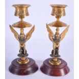 A PAIR OF 19TH CENTURY FRENCH BRASS AND MARBLE EGYPTIAN REVIVAL CANDLESTICKS. 15 cm high.