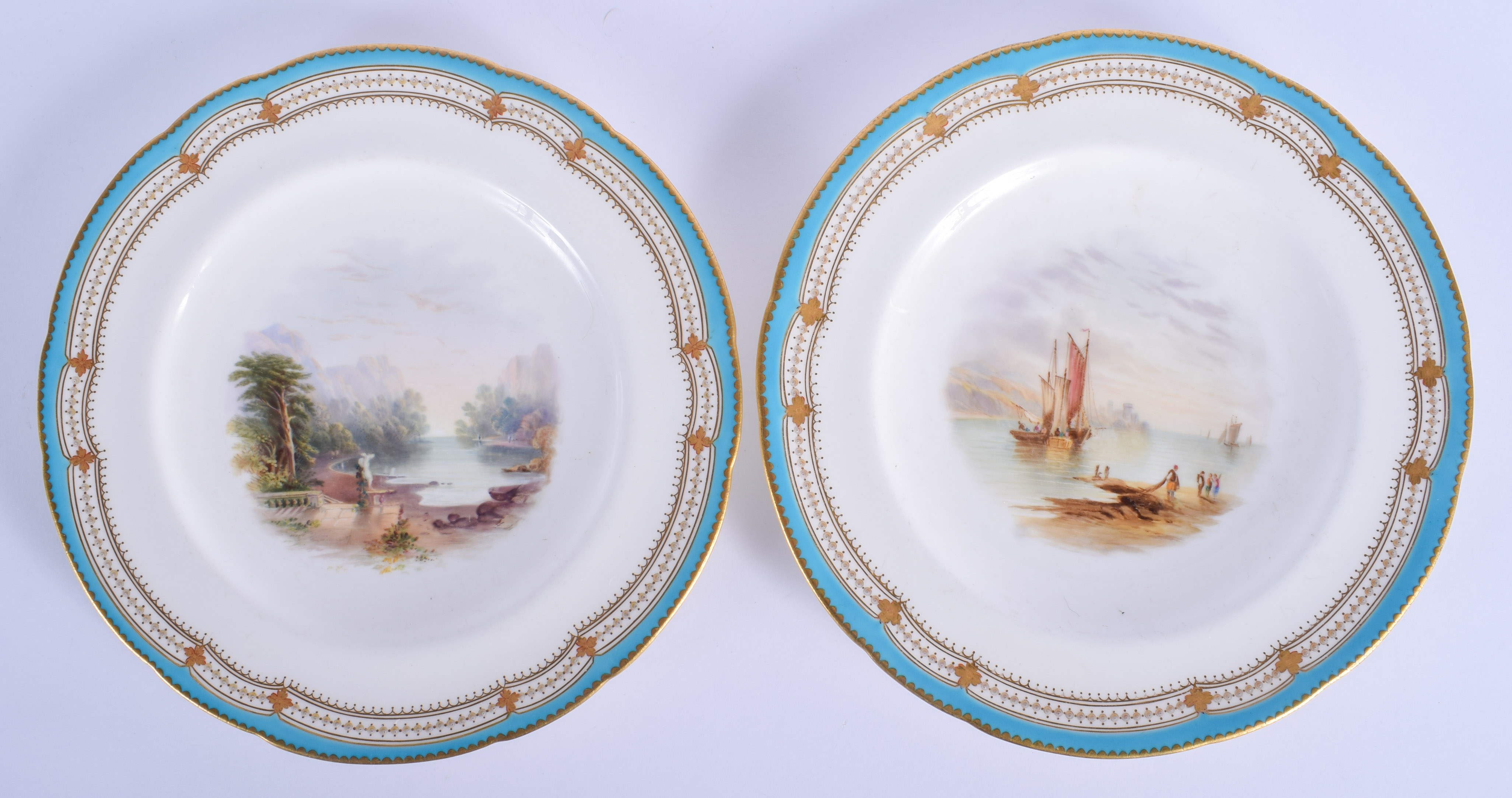 19th c. Minton pair of plates each painted with watery landscapes under a turquoise and gilt border.