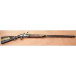 AN EARLY 20TH CENTURY FLINTLOCK WALL HANGING RIFLE with inset brass mounts. 130 cm long.