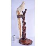 A VERY LARGE 19TH CENTURY JAPANESE MEIJI PERIOD CARVED IVORY BIRD modelled standing upon a naturalis