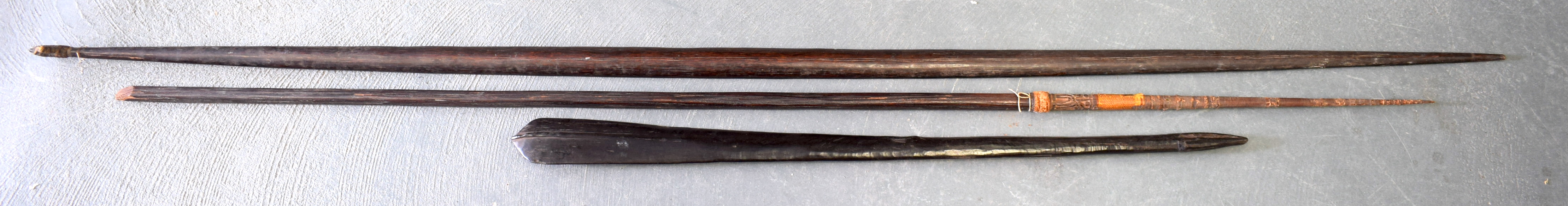 AN EARLY 20TH CENTURY POLYNESIAN TRIBAL SPEAR possibly Papua New Guinea, together with two other tri