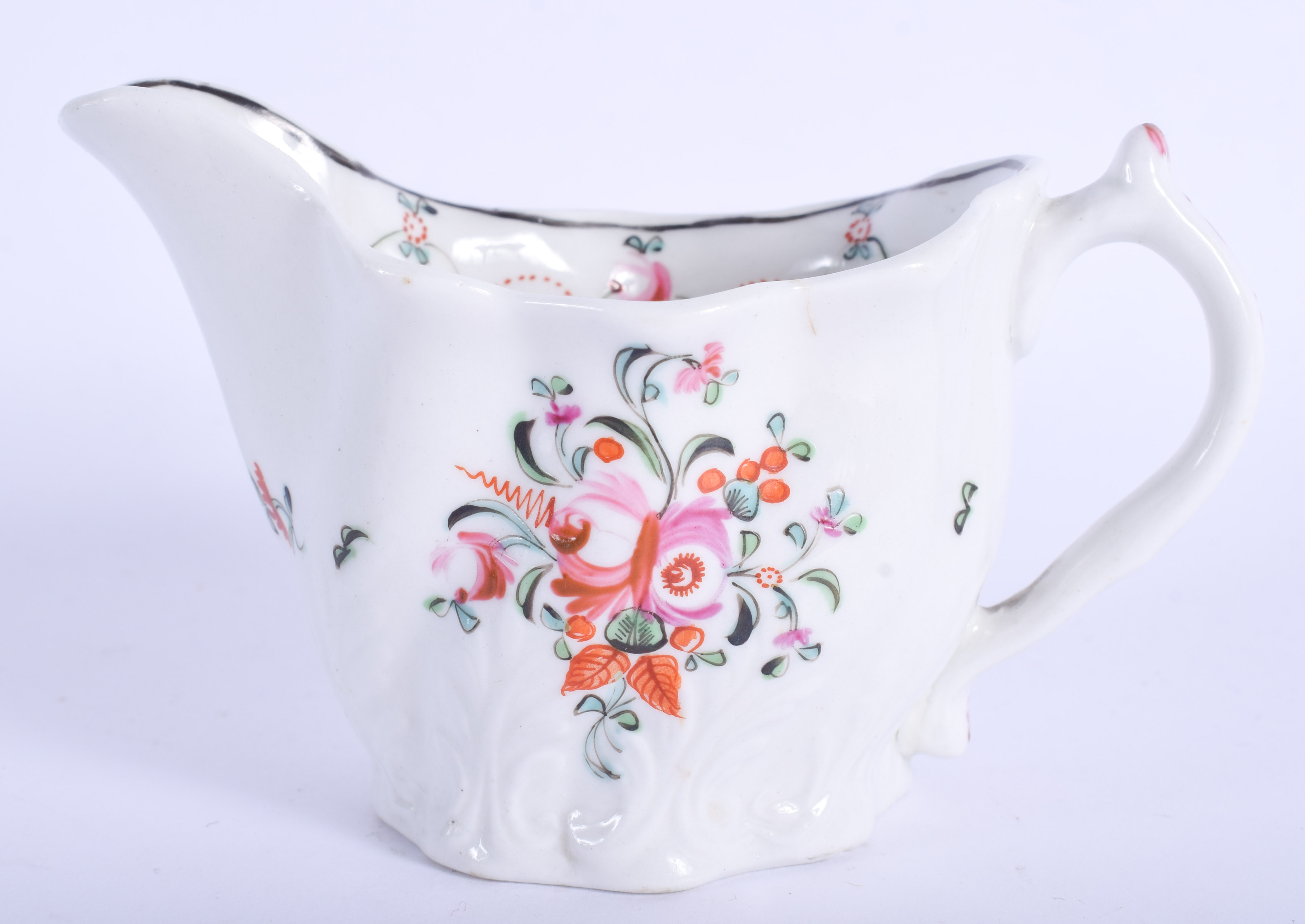 18th c. Caughley Coalport low Chelsea ewer painted with coloured flowers. 11cm wide
