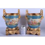 A LARGE PAIR OF SEVRES STYLE TWIN HANDLED BRONZE JARDINERES painted with putti. 34 cm x 16 cm.