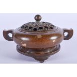 A CHINESE TWIN HANDLED BRONZE CENSER AND COVER with gold splash decoration. 10.5 cm wide, internal w