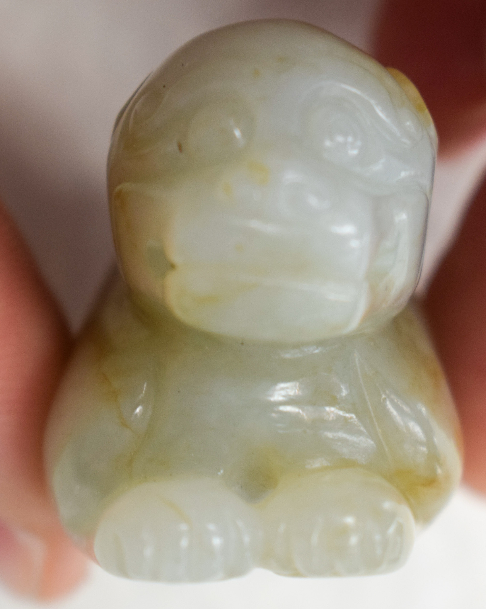 A 19TH CENTURY CHINESE CARVED GREENISH WHITE JADE BEAST Qing, with russet inclusions. 5.5 cm wide. - Image 6 of 9