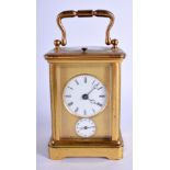 AN ANTIQUE FRENCH REPEATING BRASS CARRIAGE CLOCK with twin dial. 13.5 cm high inc handle.