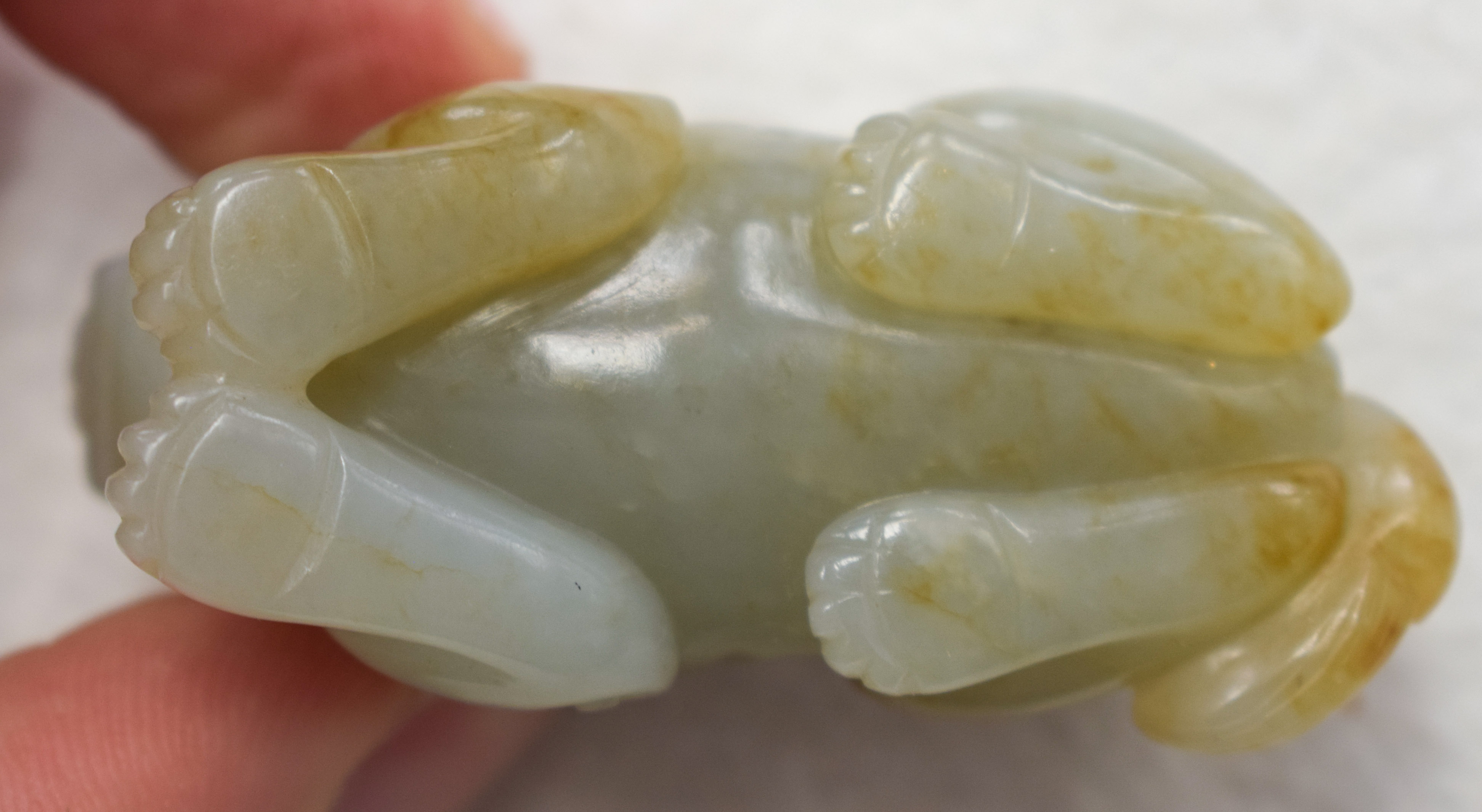 A 19TH CENTURY CHINESE CARVED GREENISH WHITE JADE BEAST Qing, with russet inclusions. 5.5 cm wide. - Image 9 of 9
