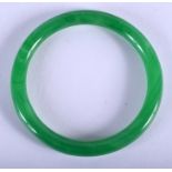 A CHINESE APPLE JADE BANGLE 20th Century. 8 cm wide.
