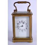 A MINIATURE ANTIQUE FRENCH BRASS CARRIAGE CLOCK with painted foliate dial. 9.5 cm high inc handle.
