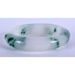 A CHINESE ICEY JADEITE BANGLE. 7.5 cm wide.