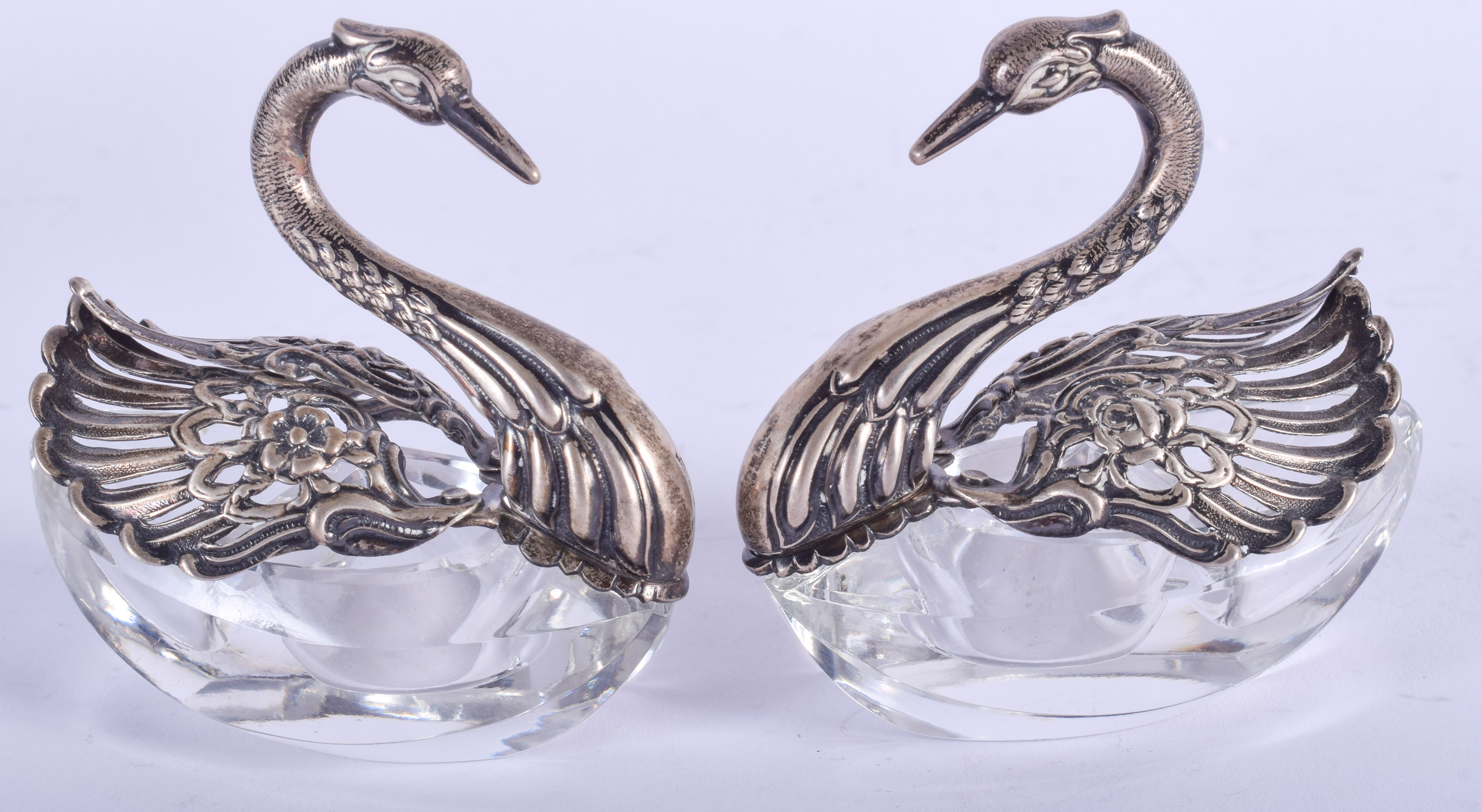 A PAIR OF CONTINENTAL SILVER AND CUT GLASS SWAN SALTS. 6.5 cm wide.