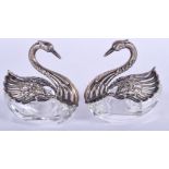A PAIR OF CONTINENTAL SILVER AND CUT GLASS SWAN SALTS. 6.5 cm wide.
