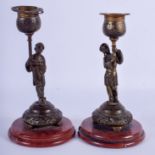 A PAIR OF 19TH CENTURY FRANCO CHINESE BRONZE CANDLESTICKS modelled as Oriental figures holding aloft