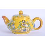 AN EARLY 20TH CENTURY CHINESE YELLOW GLAZED TEAPOT AND COVER enamelled with foliage. 13 cm wide.