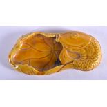 A CHINESE YELLOW PORCELAIN BRUSH WASHER formed as a coiled carp. 10 cm x 4 cm.