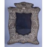 AN ART NOUVEAU ENGLISH SILVER PHOTOGRAPH FRAME depicting putti. 18 cm x 23 cm.