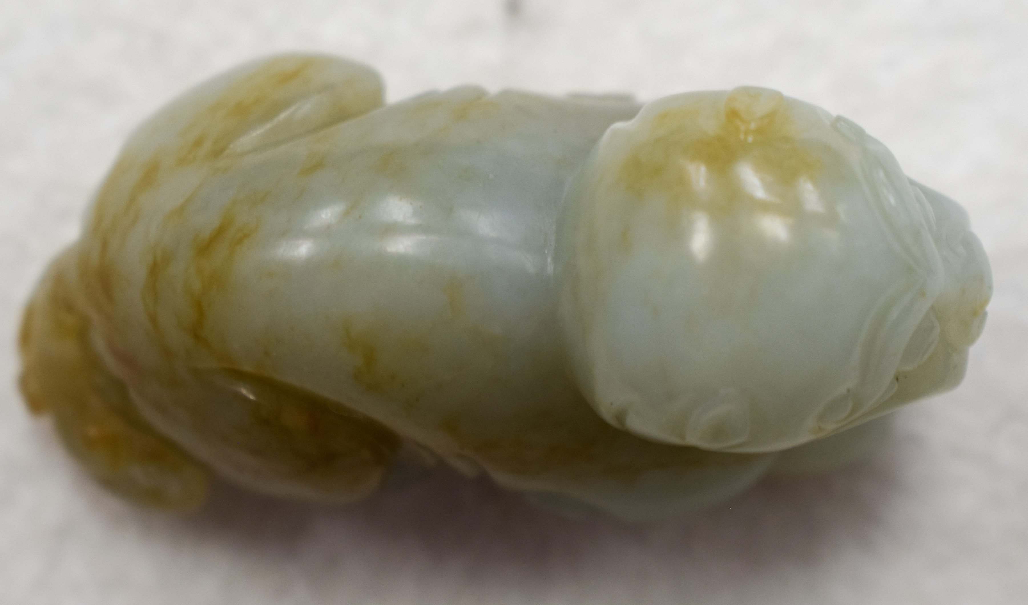 A 19TH CENTURY CHINESE CARVED GREENISH WHITE JADE BEAST Qing, with russet inclusions. 5.5 cm wide. - Image 8 of 9
