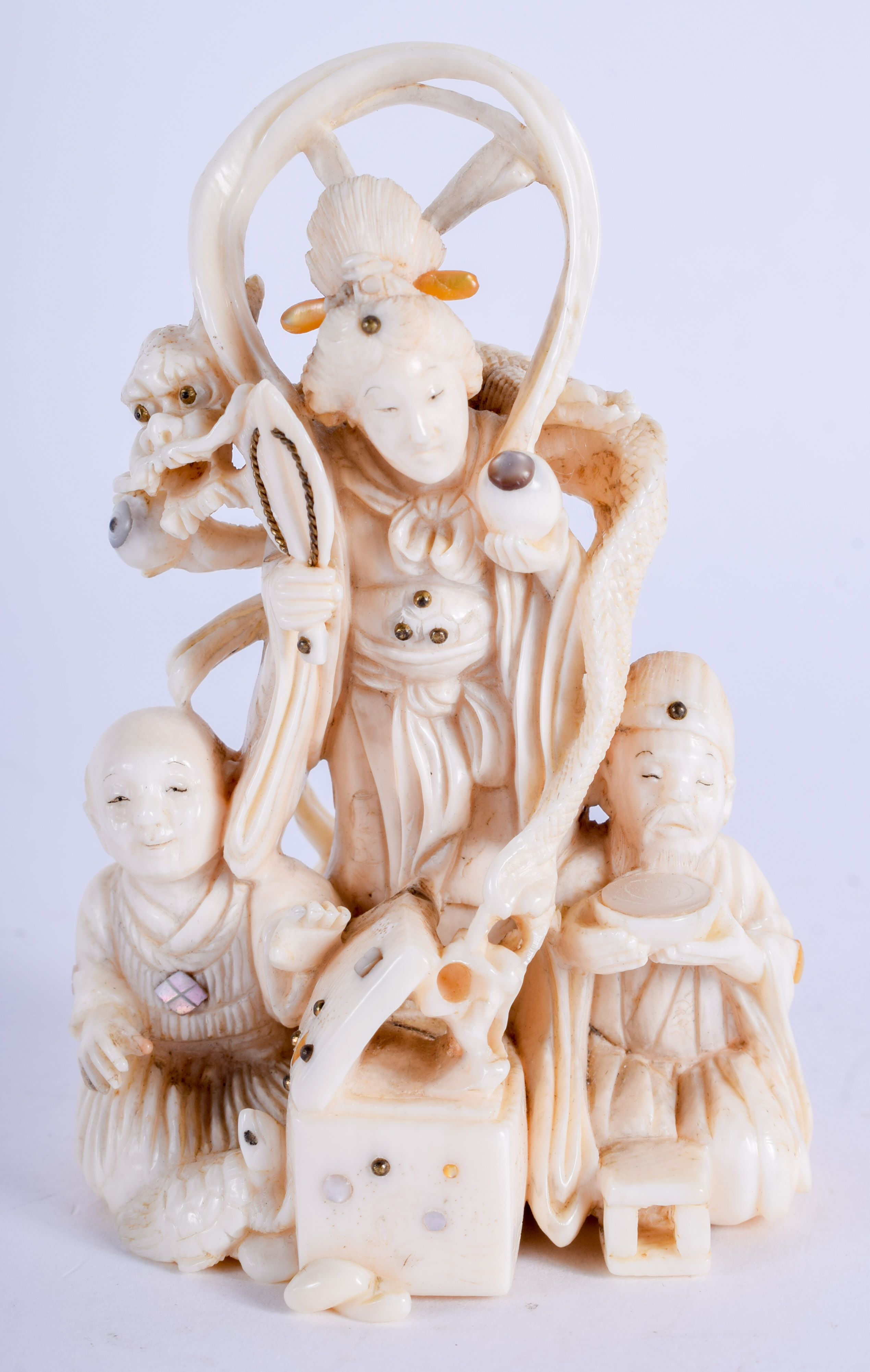 A 19TH CENTURY JAPANESE MEIJI PERIOD CARVED BONE OKIMONO modelled as a daoist immortal with two oth