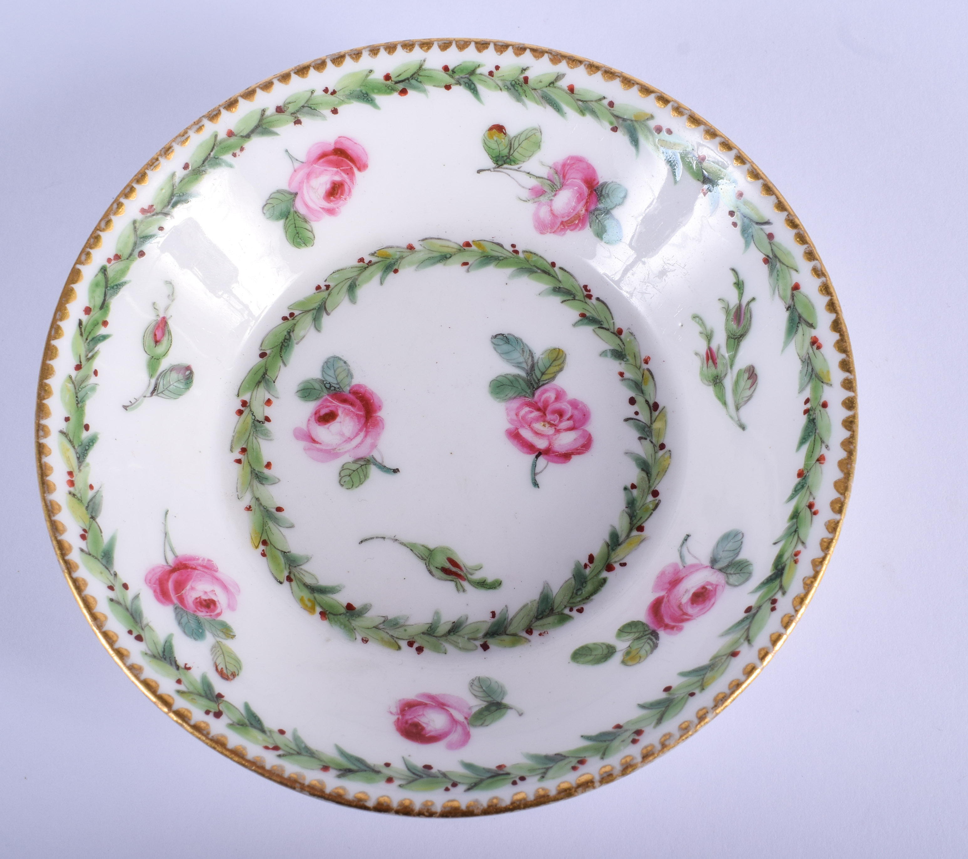 AN 18TH CENTURY SEVRES PORCELAIN SAUCER painted with roses. 12 cm wide.