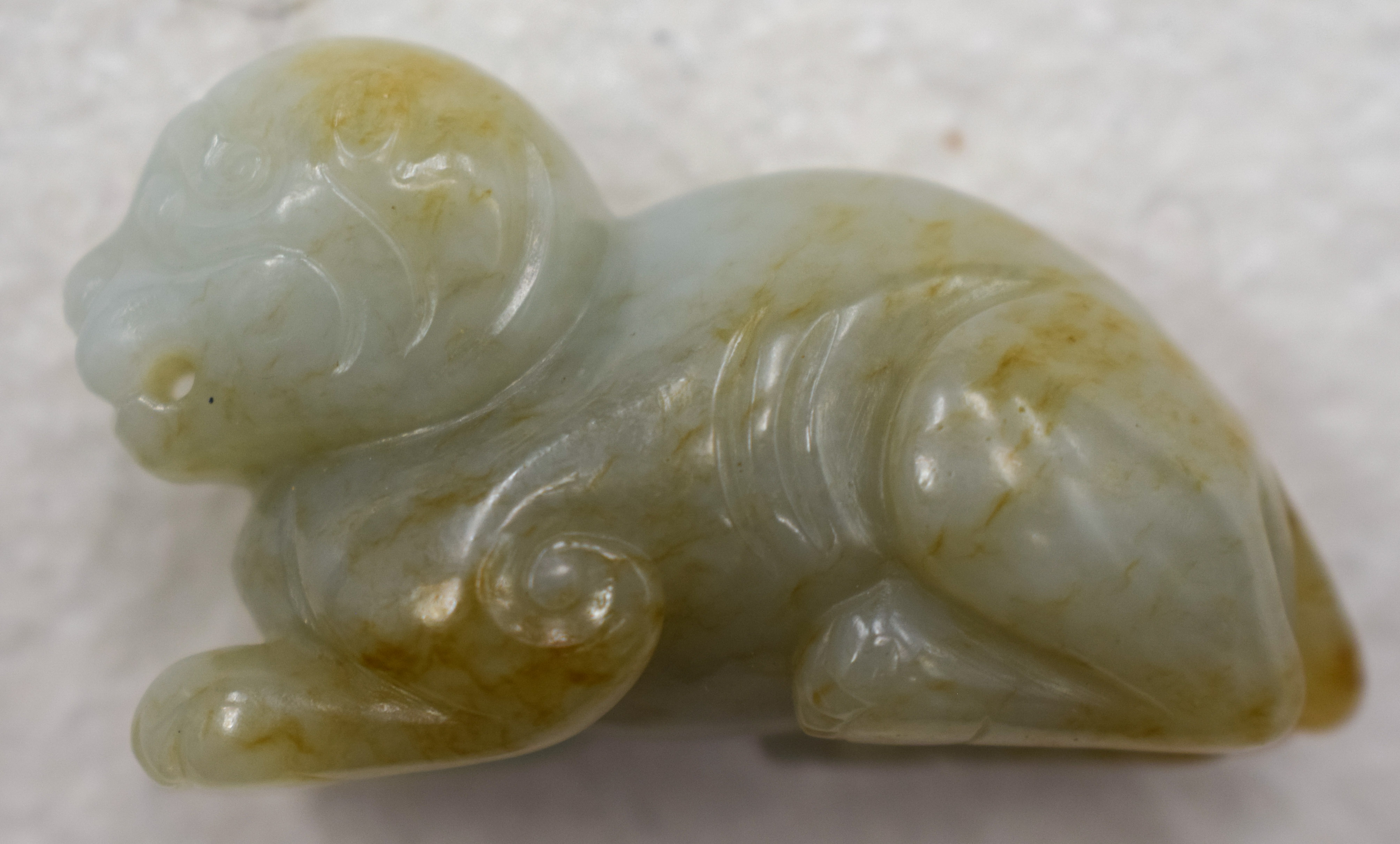 A 19TH CENTURY CHINESE CARVED GREENISH WHITE JADE BEAST Qing, with russet inclusions. 5.5 cm wide. - Image 4 of 9