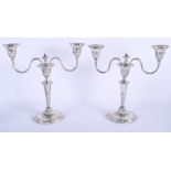 A PAIR OF ANTIQUE TWIN HANDLED ENGLISH SILVER CANDLEABRA. 1600 grams (weighted). 25 cm x 21 cm.