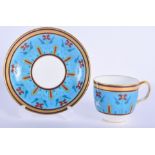 19th c. Minton coffee cup and saucer painted after Sir Christopher Dresser with red windmill like fl