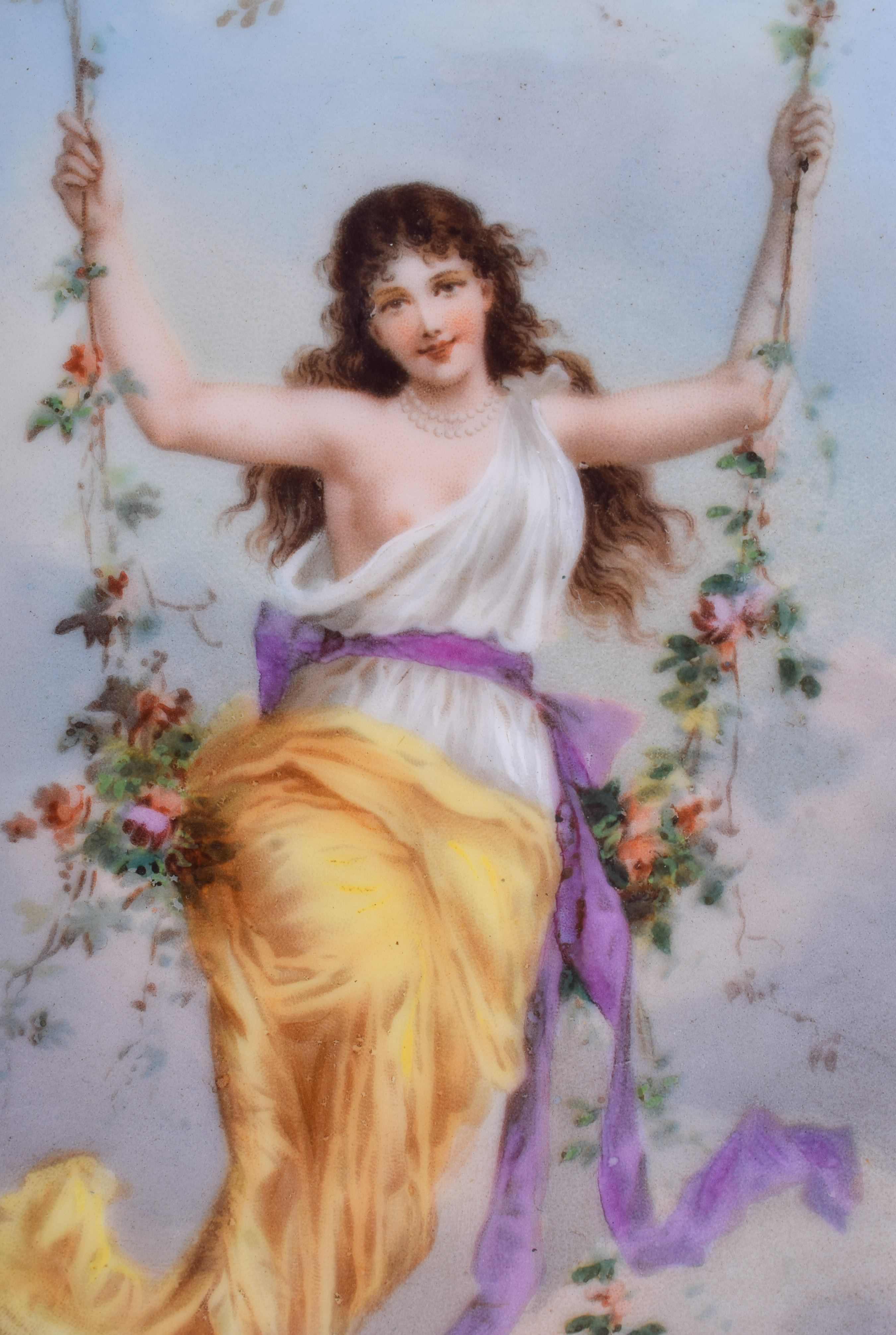 AN EARLY 20TH CENTURY EUROPEAN FAN SHAPED PORCELAIN PLAQUE painted with a female upon a floral swing - Image 2 of 3