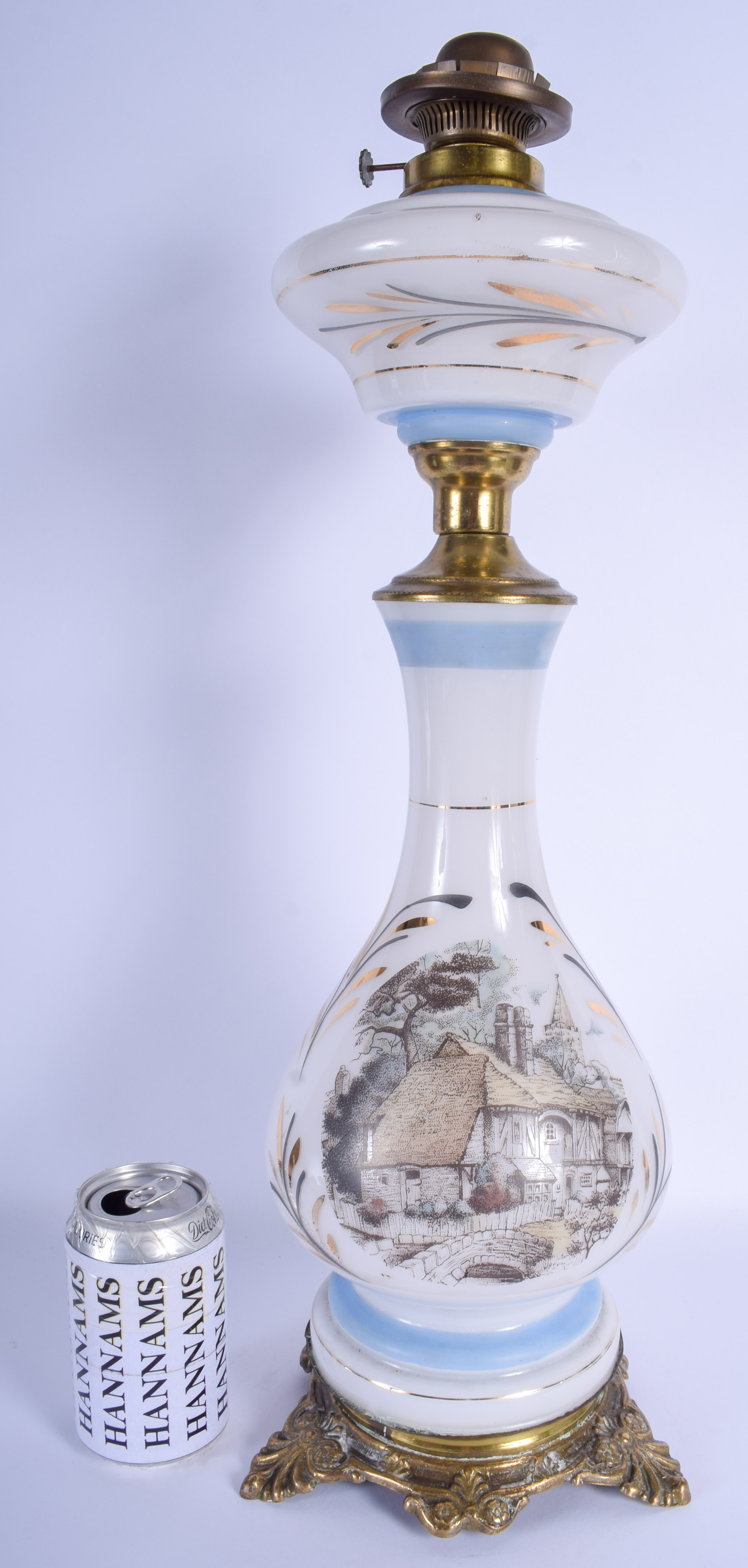 A VINTAGE OPALINE GLASS OIL LAMP decorated with buildings. 50 cm high.