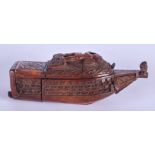 AN 18TH CENTURY CONTINENTAL CARVED COQUILLA NUT BOAT SHAPED BOX decorated with putti and birds. 11 c