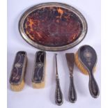 AN ANTIQUE SILVER AND TORTOISESHELL DRESSING TABLE SET. Tray 28 cm wide. (6)