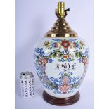 A VINTAGE DELFT FAIENCE TIN GLAZED JAR converted to a lamp, painted with foliage. Jar 29 cm x 20 cm.