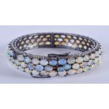 A WHITE METAL OPAL AND DIAMOND BANGLE. 41.7 grams. 7.5 cm wide.